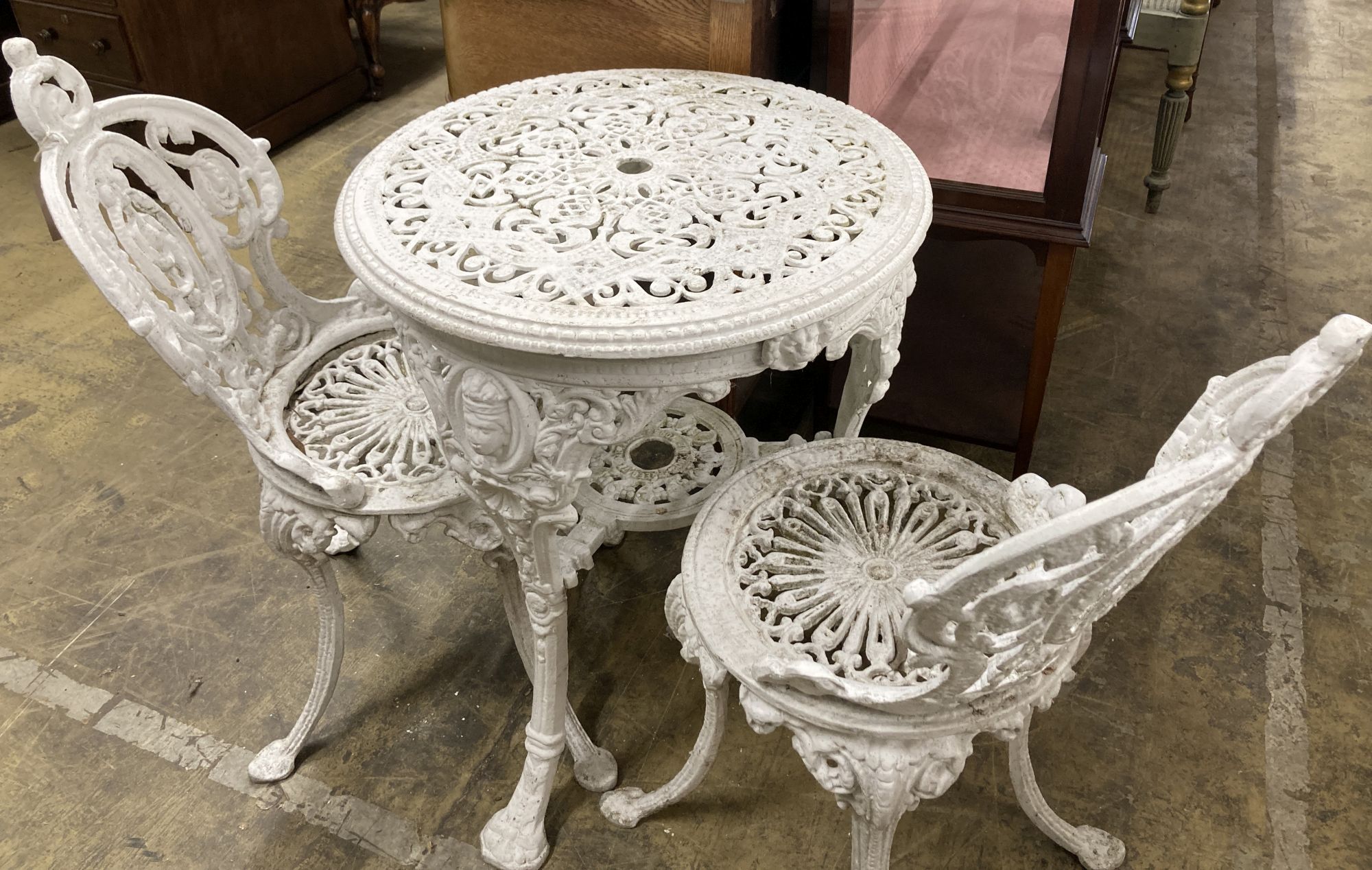 A Coalbrookdale style painted aluminium garden table, 59cm diameter, height 72cm and two chairs